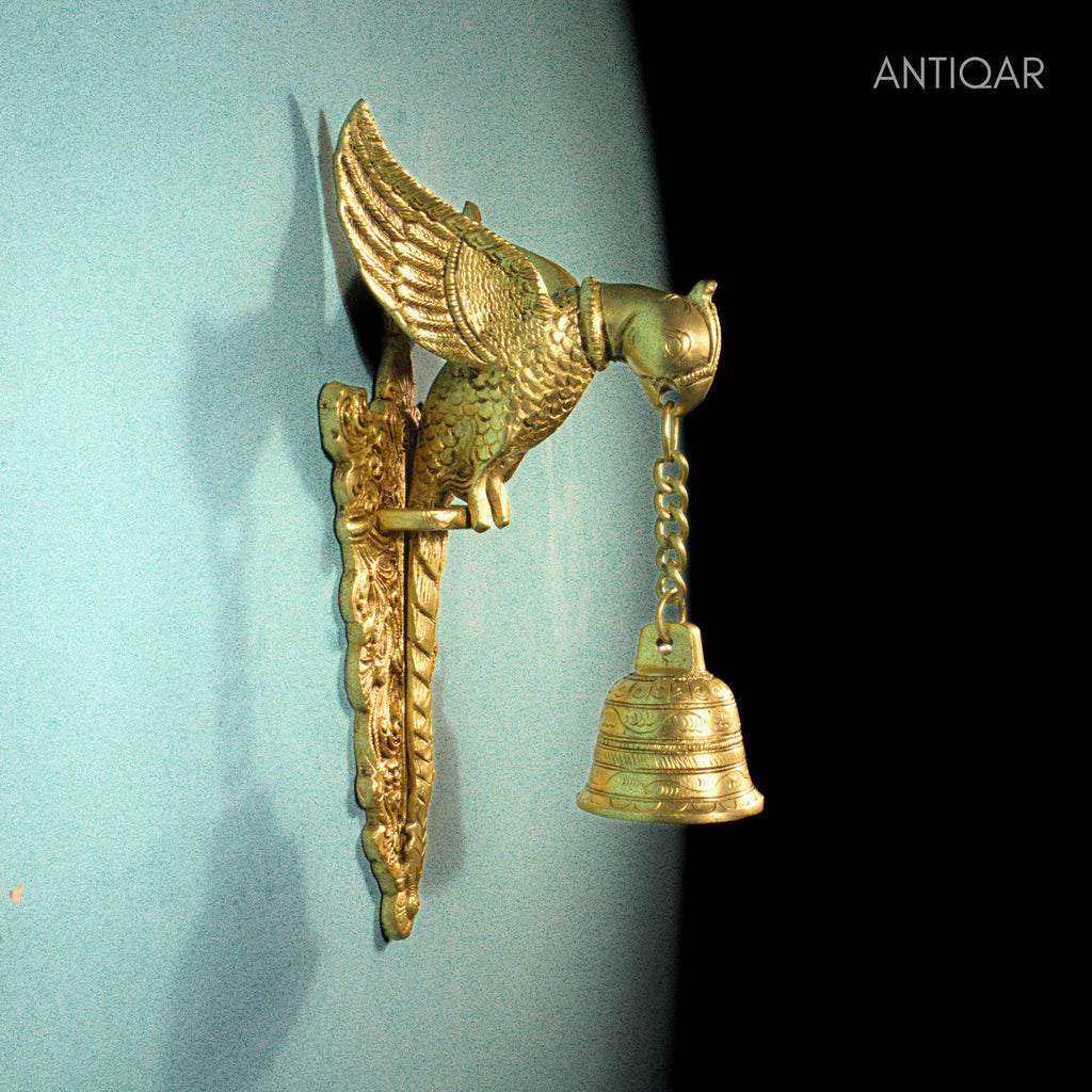 Brass Parrot Wall Hanging – 26 cm | Sitting on Tree Holding Designer Bell | Antique Golden Finish | Handcrafted Decor for Temple, Home & Wall