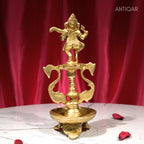 Brass Aarti Diya – 21 cm | Twin Peacock Design with Dancing Ganesha on Top | Antique Golden Finish | Handcrafted for Temple, Home & Religious Decor