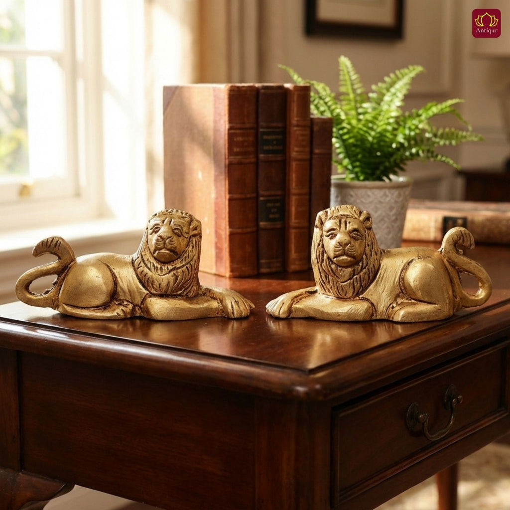 Brass Lion Pair Showpiece – 4 cm | Sitting Position | Antique Golden Finish | Handcrafted Figurines for Home, Table & Vastu Decor