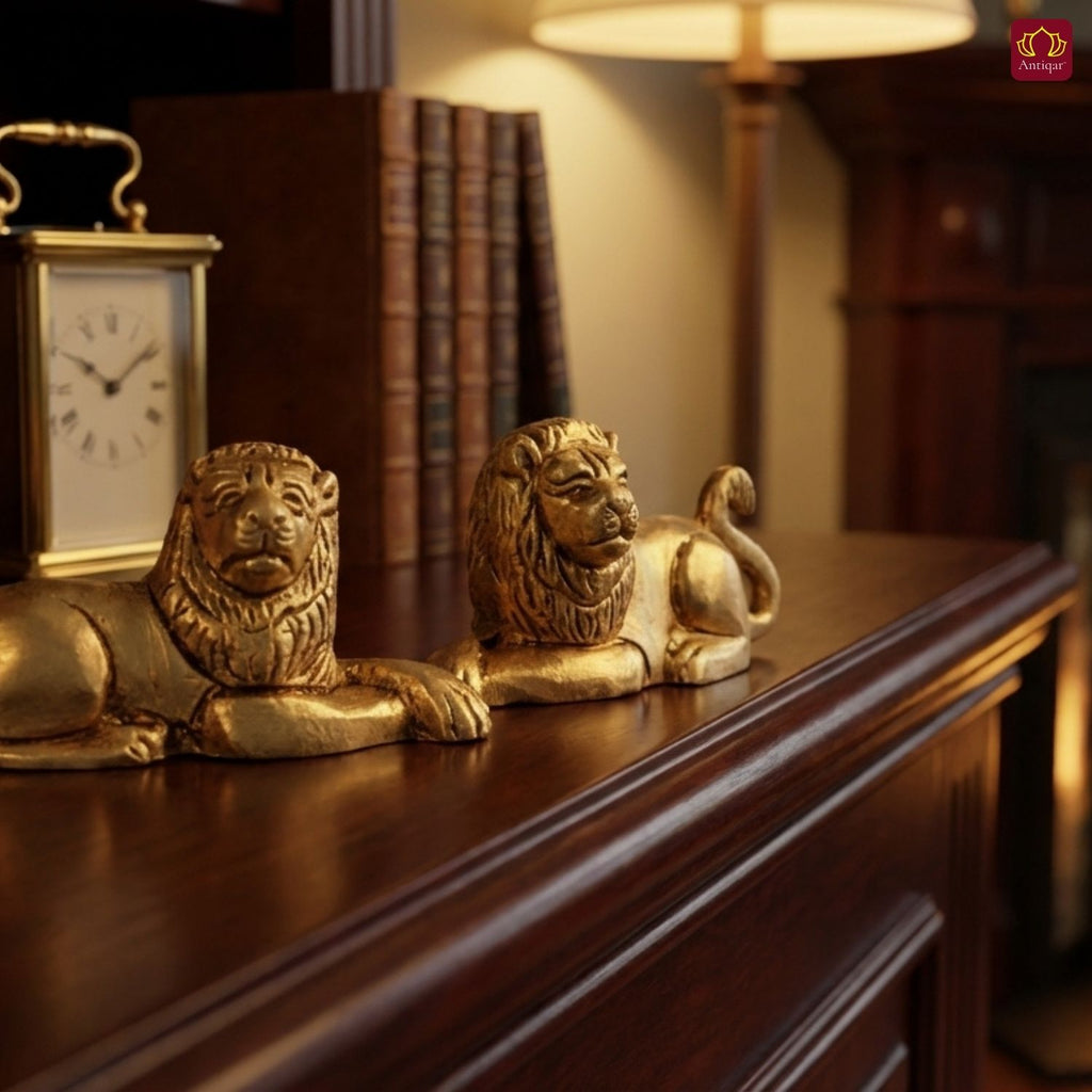Brass Lion Pair Showpiece – 4 cm | Sitting Position | Antique Golden Finish | Handcrafted Figurines for Home, Table & Vastu Decor
