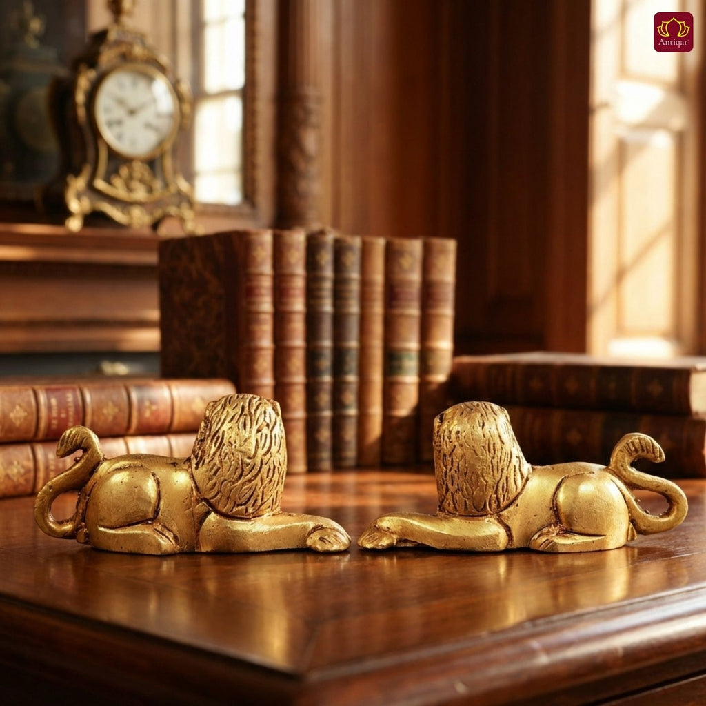 Brass Lion Pair Showpiece – 4 cm | Sitting Position | Antique Golden Finish | Handcrafted Figurines for Home, Table & Vastu Decor