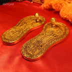 Brass Charan Paduka Pair – 3 cm | With Carved Talwar, Dhanush, Trishul & Chakra | Antique Golden Finish | Handcrafted Spiritual Decor for Temple, Home & Festival Use