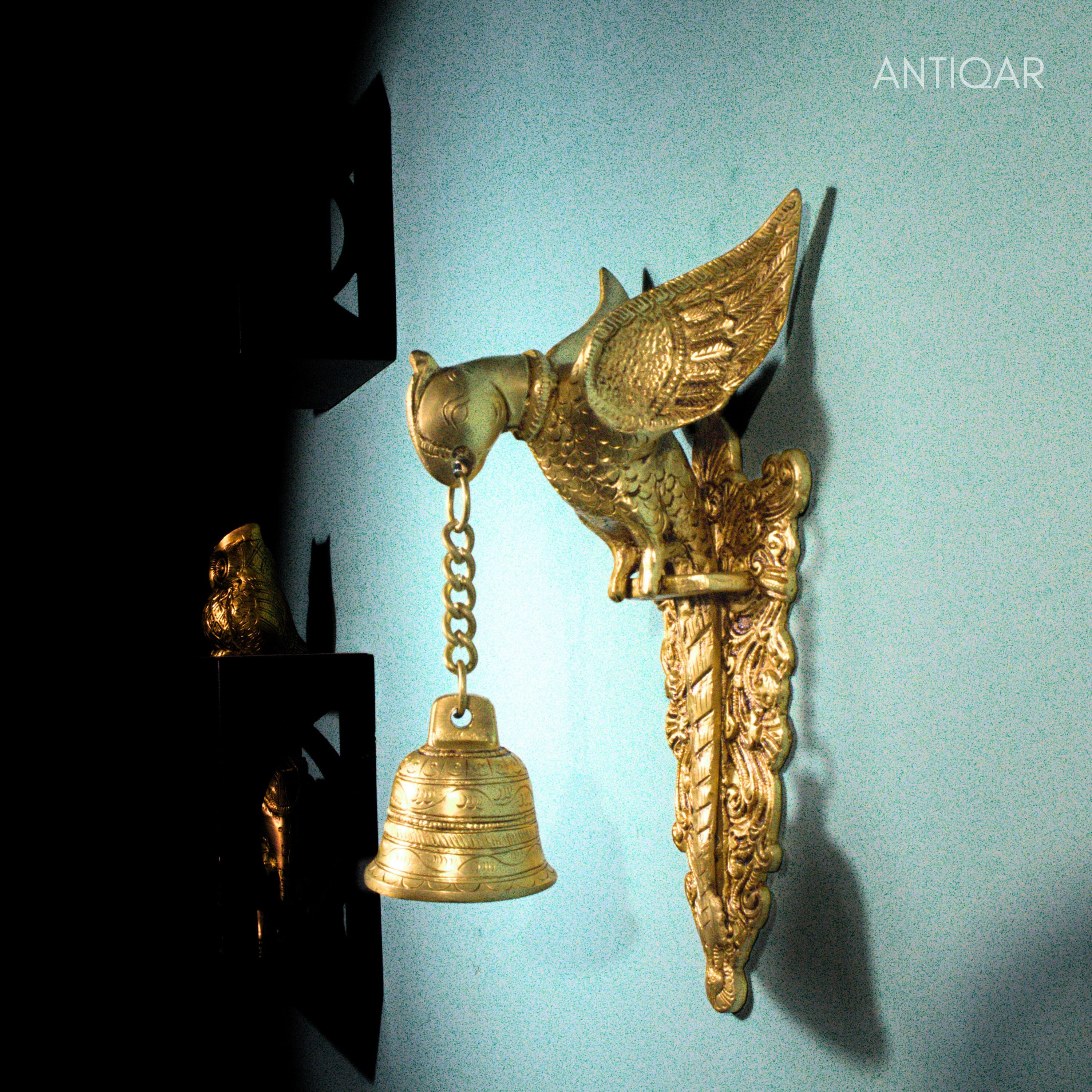 Brass Parrot Wall Hanging – 26 cm | Sitting on Tree Holding Designer Bell | Antique Golden Finish | Handcrafted Decor for Temple, Home & Wall