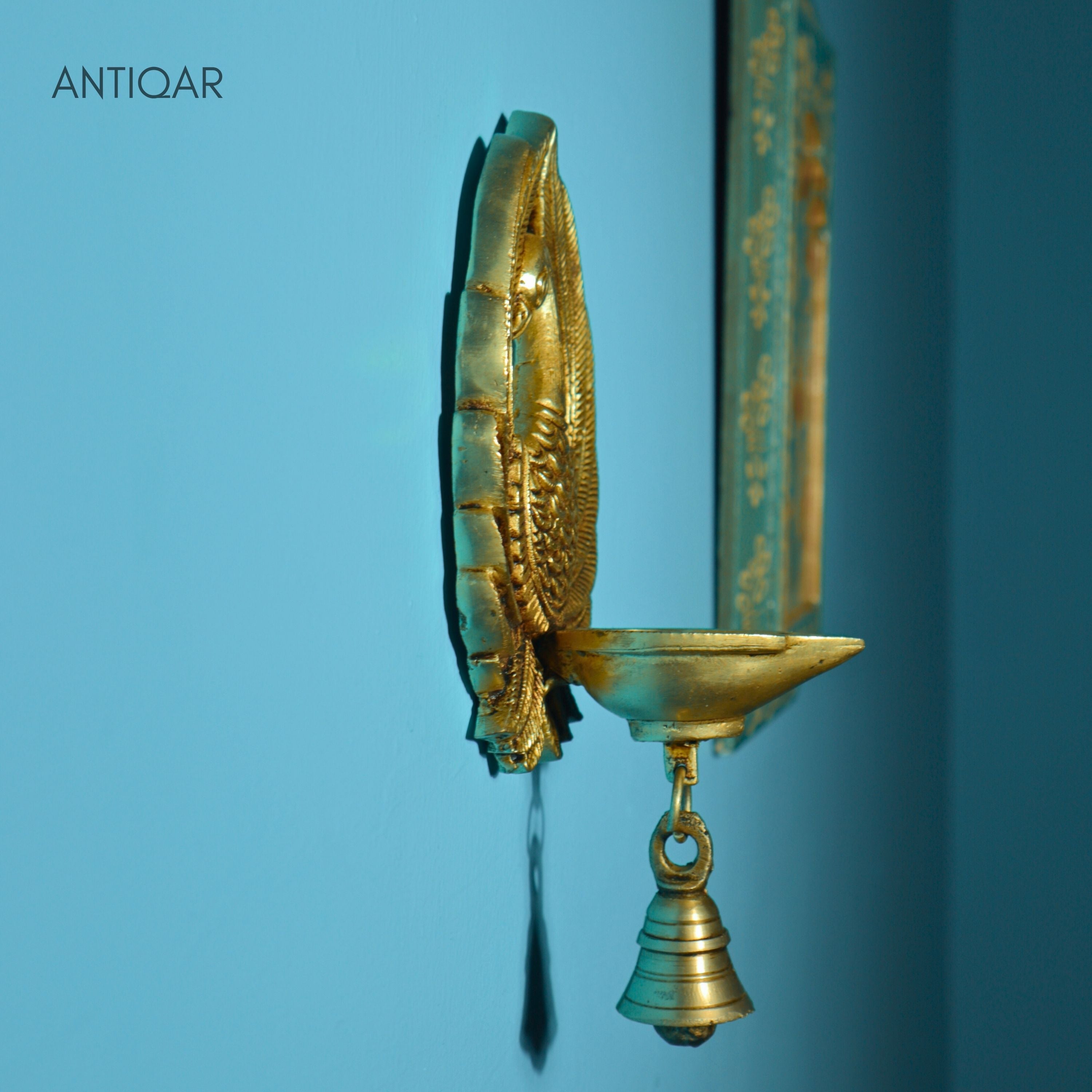 Brass Dancing Peacock Wall Hanging Diya – 23 cm | With One Bell & Intricate Carving | Antique Golden Finish | Handcrafted Decor for Temple, Home & Wall