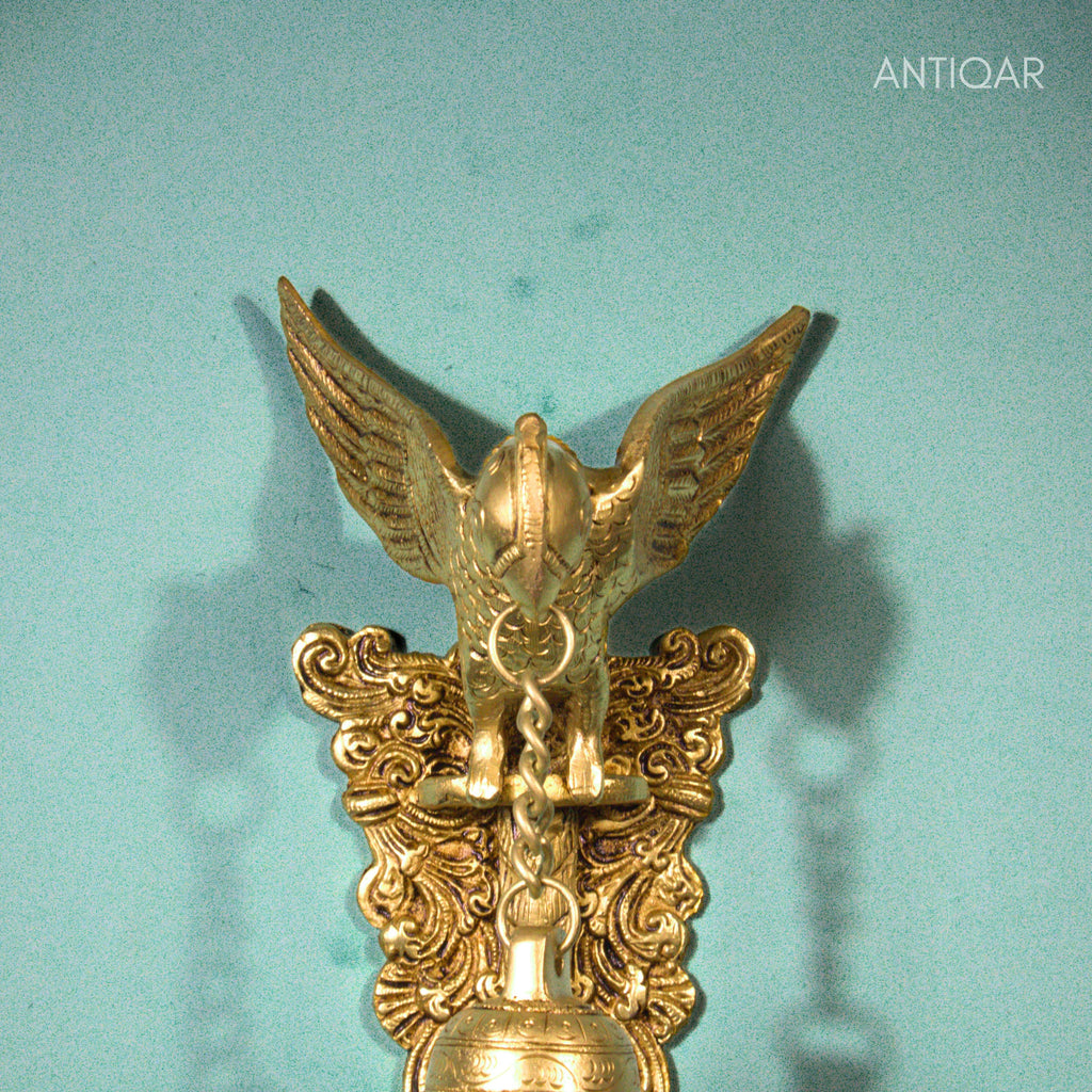 Brass Parrot Wall Hanging – 26 cm | Sitting on Tree Holding Designer Bell | Antique Golden Finish | Handcrafted Decor for Temple, Home & Wall