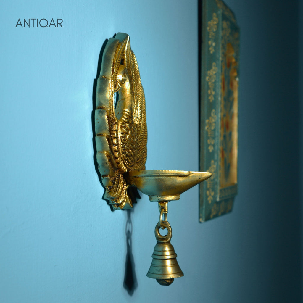 Brass Dancing Peacock Wall Hanging Diya – 23 cm | With One Bell & Intricate Carving | Antique Golden Finish | Handcrafted Decor for Temple, Home & Wall